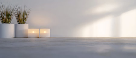 Soft light fills a minimalistic indoor corner featuring white candles and potted grass. The arrangement promotes tranquility and relaxation in a comfortable space.の素材