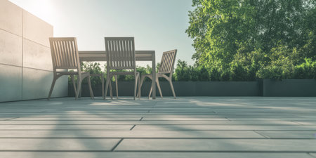 A bright terrace features a wooden table surrounded by four chairs illuminated by afternoon sunlight. Lush green plants enhance the tranquil outdoor setting creating a peaceful atmosphere.の素材