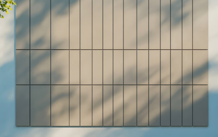 A sleek wall features a grid of rectangular panels casting intricate shadows. Natural light creates a dynamic interplay enhancing the minimalist aesthetic in an urban setting.の素材
