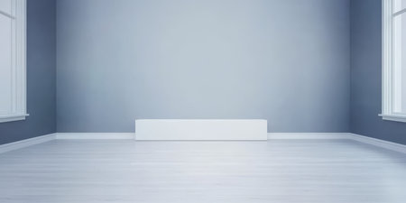 A spacious room features light gray walls and white accents including a modern radiator. Sunlight pours in through large windows highlighting the clean uncluttered space.の素材