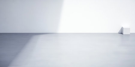 A spacious minimalist interior features a smooth light gray floor and a plain white wall. Natural sunlight streams in casting shadows and enhancing the simplicity of the design.の素材