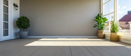 Sunlight streams through large windows illuminating a spacious room with wooden flooring. Potted plants are placed neatly near the windows enhancing the inviting atmosphere.の素材