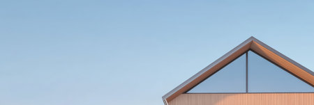 This structure features a slanted roof and expansive glass window emphasizing modern architecture. The clear sky provides a serene backdrop highlighting the buildings clean lines and style.の素材