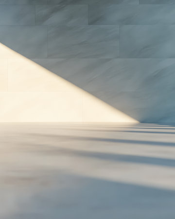 Soft light filters through creating a dynamic interplay of shadows on a muted surface. The tranquil ambiance suggests creativity and minimalism in an indoor environment.の素材