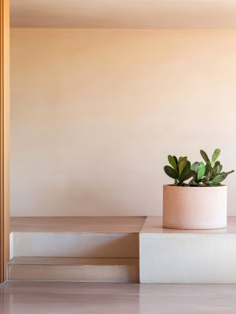 A tranquil minimalist interior showcases a large potted plant placed on a simple raised platform. Soft natural colors enhance the peaceful atmosphere in the room.の素材