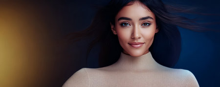 A woman with long flowing hair smiles softly showcasing a warm expression. The background is artistically lit enhancing her features and creating a relaxed atmosphere as she poses for the camera.の素材