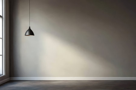 A spacious room with gray walls and a large window allows natural light to filter in. A lone pendant light hangs from the ceiling adding a touch of modern design to the minimalist setting.の素材