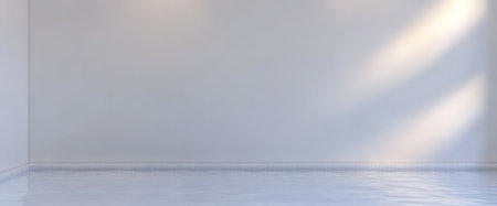 An empty room featuring bright white walls and a shiny floor. Natural light streams in creating a calm and inviting atmosphere perfect for various activities or decoration.の素材