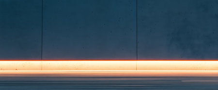 A minimalist setting featuring a smooth concrete wall illuminated by a warm light strip at the base. The contrast highlights the simplicity and elegance of the design creating a serene atmosphere.の素材