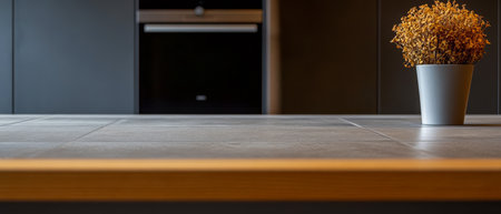 A stylish kitchen features a sleek countertop with wooden trim. A small potted plant adds a touch of nature to the modern space creating a cozy and inviting atmosphere.の素材