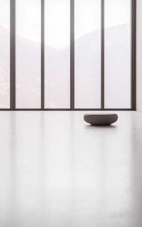 Bright and airy interior with floor-to-ceiling windows showcasing a serene landscape. A single round decorative bowl sits centrally on a smooth light floor enhancing the minimalist aesthetic.の素材