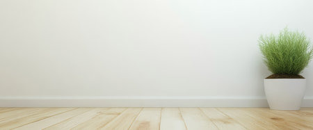 A stylish indoor area showcases a potted green plant placed on a wooden floor. The background features a simple white wall creating a fresh and calming atmosphere.の素材