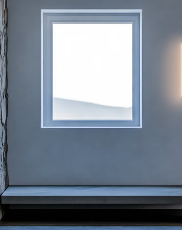 A minimalistic room features a sizable window allowing natural light to fill the space. The soft gray walls enhance the contemporary design. Simple furnishings complete the aesthetic.の素材
