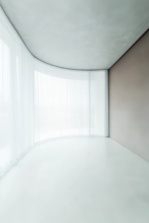 Bright and airy interior featuring curved walls smooth concrete flooring and sheer curtains allowing natural light to fill the space creating a serene atmosphere perfect for relaxation.の素材