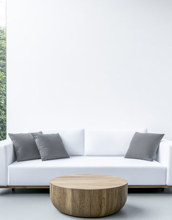 Clean and bright living room showcases a contemporary white sofa adorned with gray cushions. A round wooden coffee table sits in front creating a stylish welcoming atmosphere.の素材