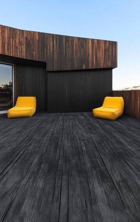 Spacious balcony showcases two yellow loungers on dark wooden flooring. Sunlight illuminates the area against a backdrop of a stylish wooden structure creating a contemporary atmosphere.の素材