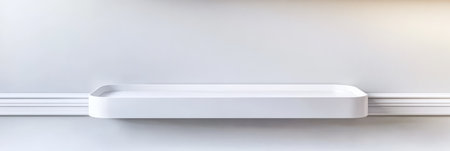 A minimalist white shelf is mounted on a clean wall with a subtle design. The simplified background enhances the shelfs elegance creating a spacious and airy atmosphere.の素材