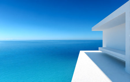 A contemporary white structure extends over a serene azure sea capturing a perfect view of the clear sky and water on a sunny day. The design emphasizes simplicity and tranquility.の素材