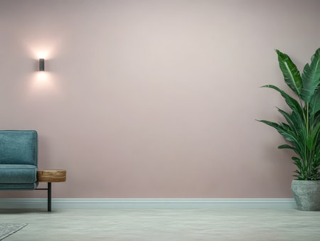 A spacious living area features a light pink wall a teal couch with a wooden accent and a large green plant in a decorative pot. The setup embodies a contemporary aesthetic.の素材
