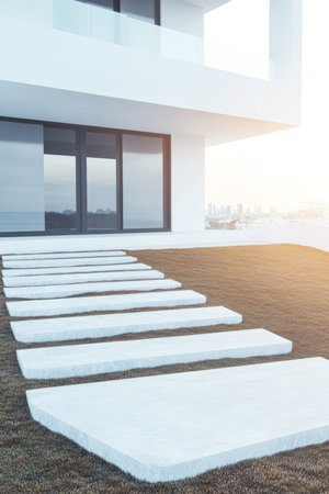 White stepping stones lead across a green lawn toward a contemporary building. The scene is set in an urban area during the early morning highlighting modern design elements.の素材