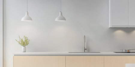 A contemporary kitchen features a clean countertop with a sink stylish pendant lights and a small plant in a vase for a touch of greenery. The space exudes simplicity and elegance.の素材