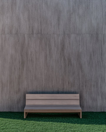 A simple wooden bench is placed on lush green grass in front of a smooth gray wall. The design emphasizes minimalism creating a peaceful outdoor atmosphere ideal for relaxation.の素材