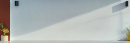 A spacious minimalist interior features a clean white wall illuminated by sunlight. On either side vibrant potted plants add life to the setting creating a harmonious design.の素材