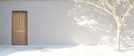 A plain wooden door sits on a light gray wall accompanied by the shadow of a lifeless tree. The scene is illuminated by natural daylight creating serene and minimalist vibes.の素材
