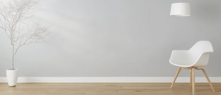 Bright and airy room with a light gray wall showcasing a stylish white chair and a decorative tree in a contemporary pot. Natural light enhances the minimalist aesthetic and spacious feel.の素材