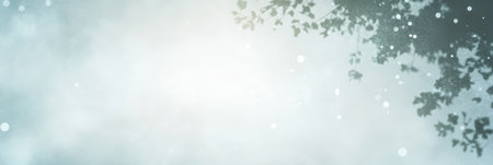 Soft sunlight streams through leafy branches creating a serene ambiance. Dust particles float in the gentle light evoking a peaceful morning atmosphere in nature.の素材