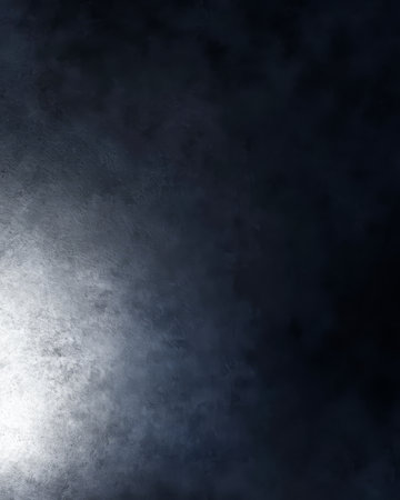 A textured background showcases shades of dark gray with a soft light emerging from one corner giving a sense of depth. The contrast creates an intriguing visual effect ideal for artistic projects.の素材