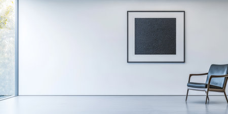 A spacious interior showcases a minimalist design featuring a gray chair and a large black artwork framed on the wall. Natural light floods the room enhancing its simplicity.の素材