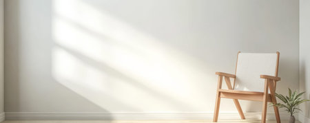 Soft sunlight streams into a bright room highlighting a simple wooden chair next to a small indoor plant. The minimalist design creates a serene and inviting atmosphere.の素材