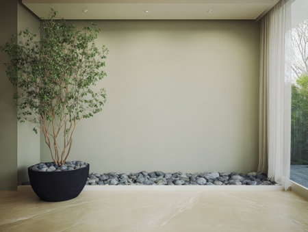 This space showcases a minimalist approach with a potted tree and a stone garden. Natural light filters through large windows creating a calming atmosphere perfect for relaxation.の素材