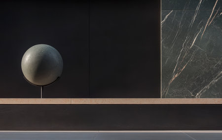 A large spherical sculpture stands on a pedestal in a sleek architectural space. The backdrop features dark and light marble textures highlighting the elegance of the design.の素材