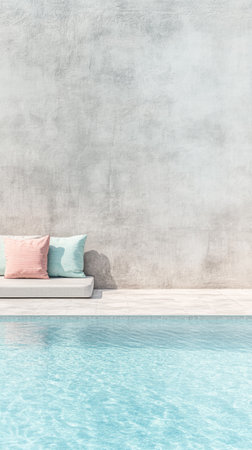 A cozy outdoor seating area features pastel cushions on a sleek couch beside a crystal-clear swimming pool. The minimalist wall adds a tranquil vibe to the setting on a sunny day.の素材