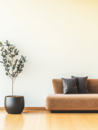 A modern living room features a sleek brown sofa adorned with black cushions alongside a decorative indoor plant in a stylish pot. Natural light enhances the minimalistic space.の素材