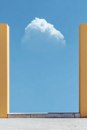Yellow walls create a striking frame for a fluffy white cloud in a bright blue sky. This scene captures a moment of tranquility in a minimalist setting.の素材