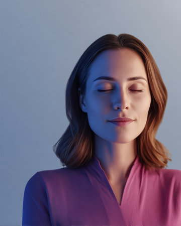 A young woman with shoulder-length brown hair enjoys a moment of peace, her eyes closed and a gentle smile on her lips. Soft blue lighting enhances the serene atmosphere.の素材