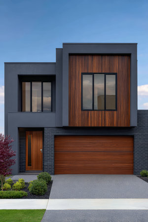 A contemporary home features a mix of dark gray and wooden elements. Its large windows allow natural light to brighten the interior, while a well-kept lawn frames the entrance.の素材