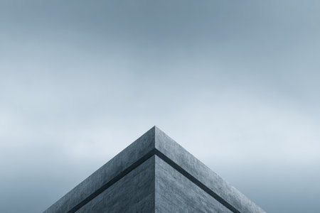 An angular, minimalist building rises sharply against a backdrop of overcast skies during twilight. The interplay of geometry and light creates an intriguing silhouette.の素材