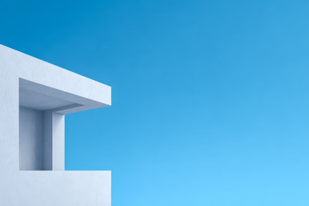 A modern structure displays a sharp corner with a smooth white finish against a bright blue sky. The minimalist design offers a calm and refreshing view, emphasizing simplicity.の素材