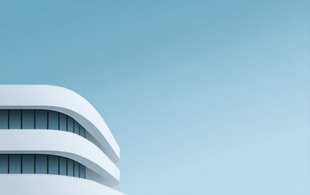 A sleek building features smooth, curved lines and large windows, contrasted against a bright blue sky. The design reflects contemporary style and innovation.の素材