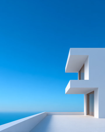 A striking minimalist building features sleek lines and large windows, providing breathtaking views of the ocean beneath a vibrant blue sky, creating a peaceful atmosphere.の素材