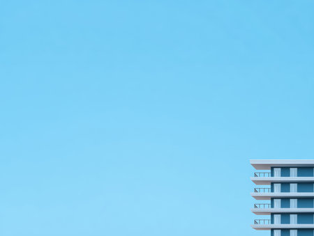 A sleek modern building stands tall against a bright blue sky. The design features clean lines and a minimalist style, representing urban architecture in a lively environment.の素材