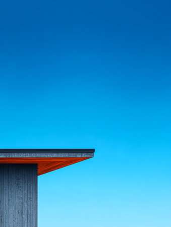A sleek structure with wooden accents stands against a vibrant blue sky, showcasing modern architectural design. The scene captures tranquility and minimalism in outdoor space.の素材
