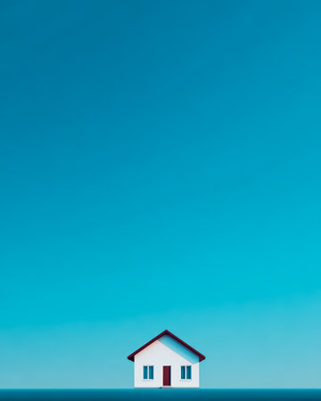 A small house with a red door and windows sits on the edge of a calm horizon, under a vibrant blue sky. The scene exudes a sense of peace and simplicity in nature.の素材