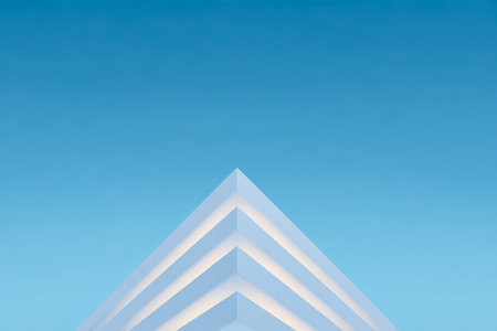 A striking white building features sharp angles and layers, captured against a vivid blue sky. The design emphasizes simplicity and modern aesthetics that attract attention.の素材