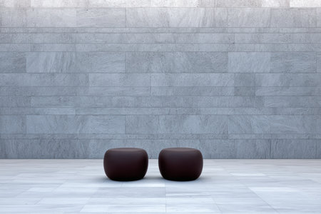 Two rounded, dark brown seating options sit against a smooth gray stone wall in a minimalist indoor space, creating a calm and modern atmosphere.の素材