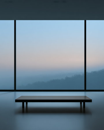 A spacious indoor area features a simple table against large windows showcasing a serene mountain landscape in twilight hues.の素材